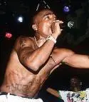 TUPAC SHAKUR - 220px-Tupac_Shakur_(rapper),_performing_live.jpg